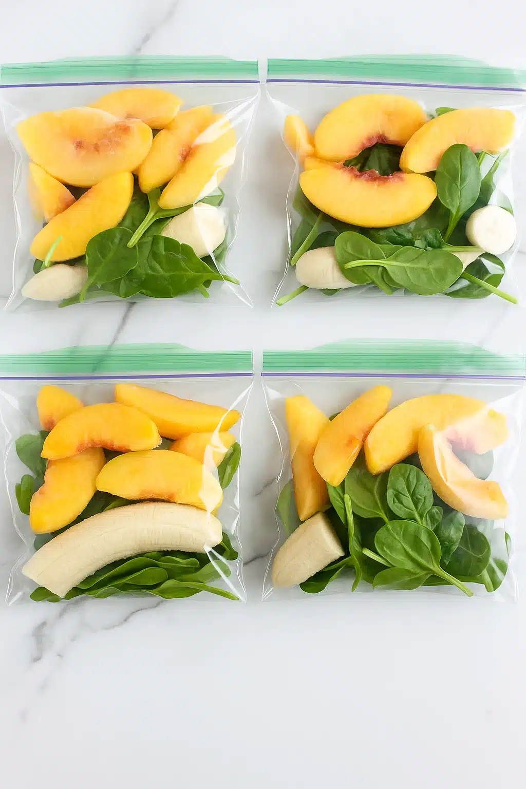Four freezer prep bags filled with fruit