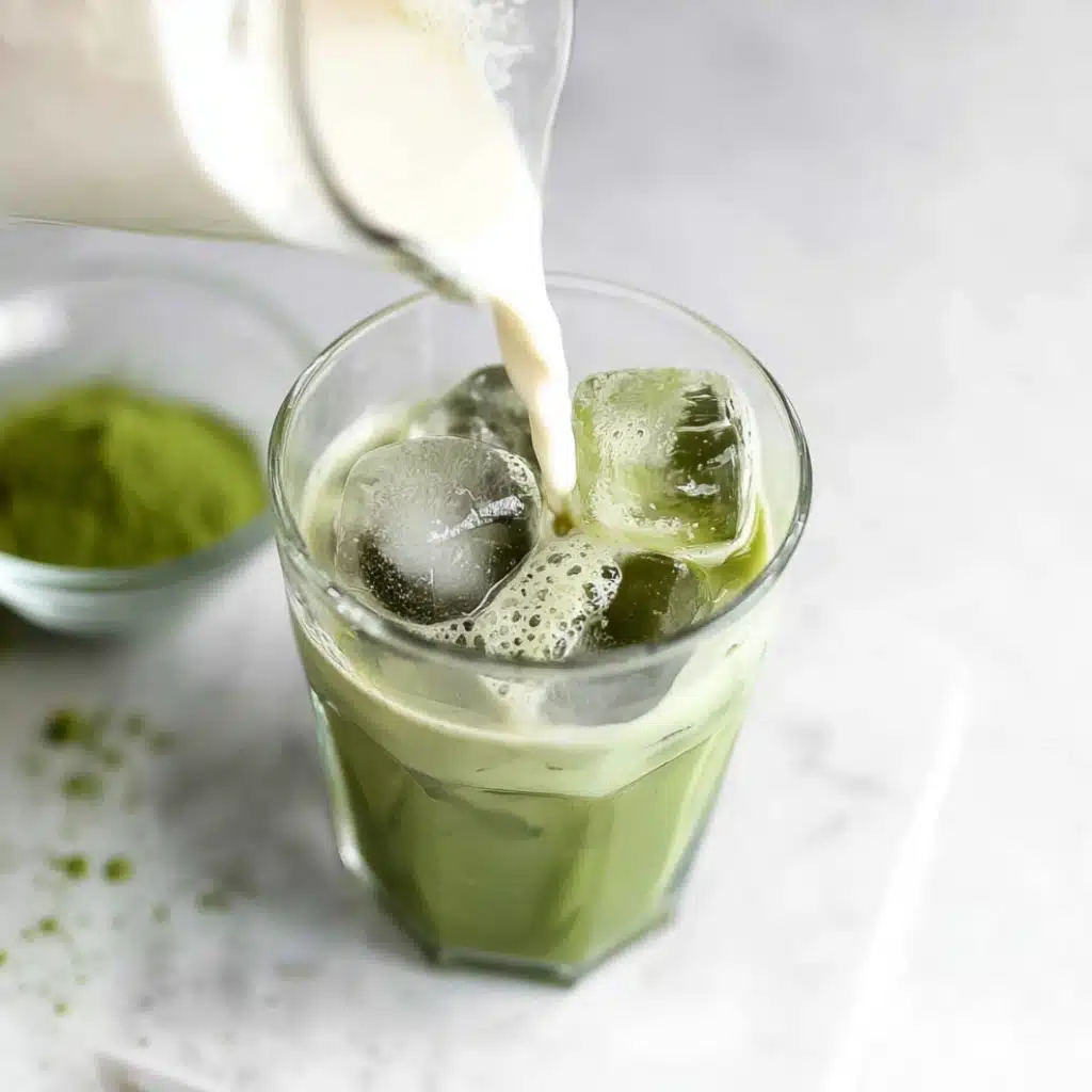 Low Calorie Iced Matcha Latte being poured with almond milk