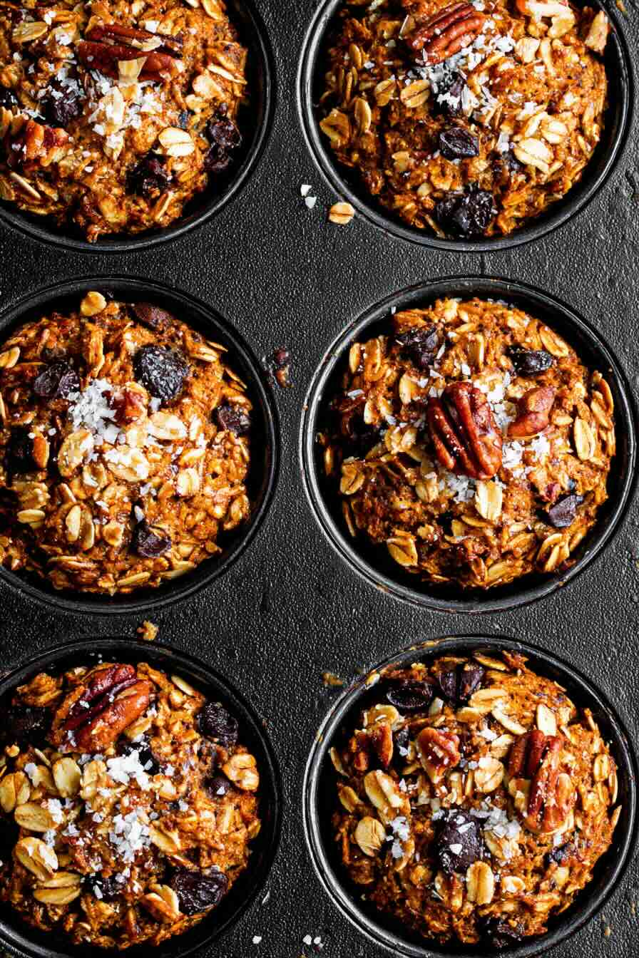 Close-up of baked pumpkin oatmeal cups with oats, chocolate chips, and pecans